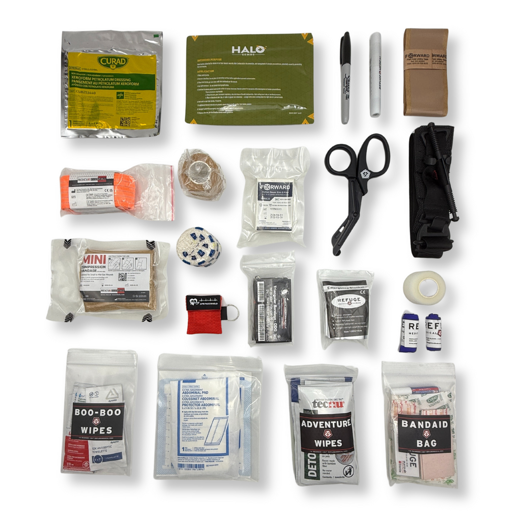Collection of first aid supplies including bandages, scissors, and other medical items on a white background